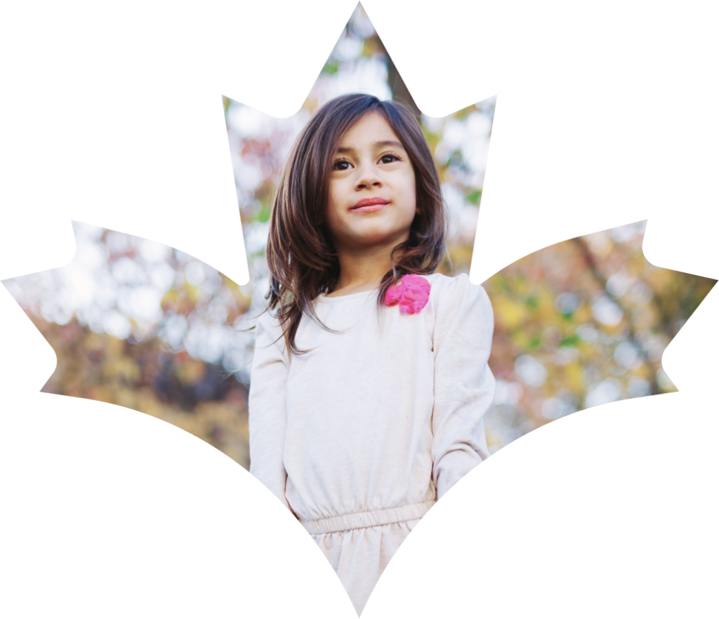 Child standing proud in a maple leaf