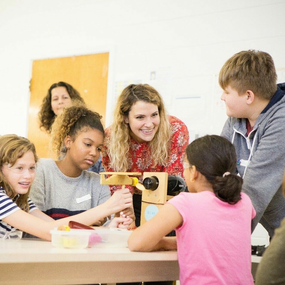 students and teacher at desk