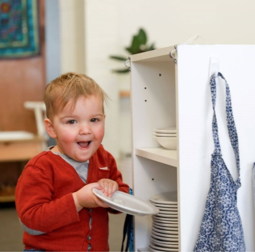 boy student with plates in classroom